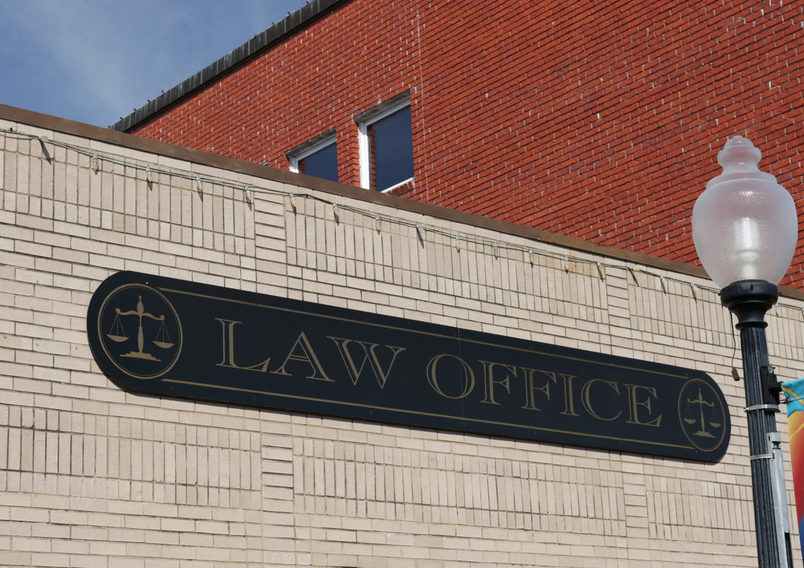 Law firm website design: a law office sign on a small downtown building