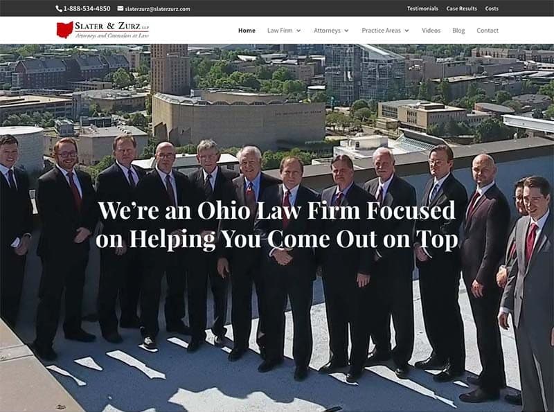 Slater & Zurz website design: the 2017 homepage, the firm's attorneys on a rooftop over Akron, with the line "We're an Ohio Law Firm Focused on Helping You Come Out on Top"