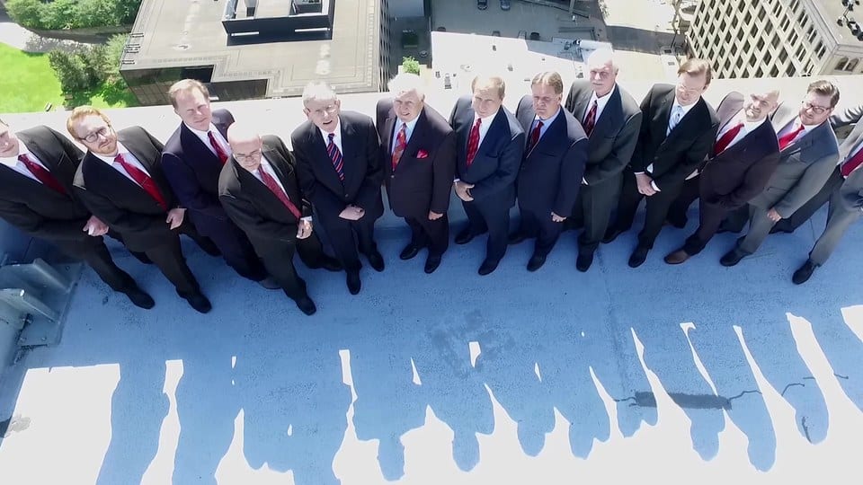 Slater & Zurz website design: a frame from the 2017 homepage video, the firm's attorneys standing together on the roof