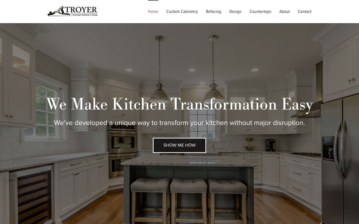 Troyer Transformations website design: the homepage, with a white kitchen and the line "We Make Kitchen Transformation Easy"