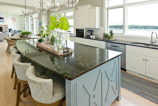 Troyer Transformations website design: one of the kitchen photos on the site, an island with a curved granite top and a lake view