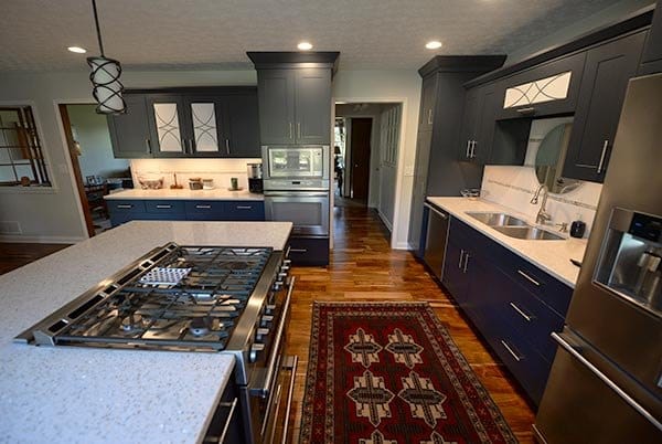 Troyer Transformations website design: one of the kitchen photos on the site, dark upper cabinets, navy lower cabinets and a long island