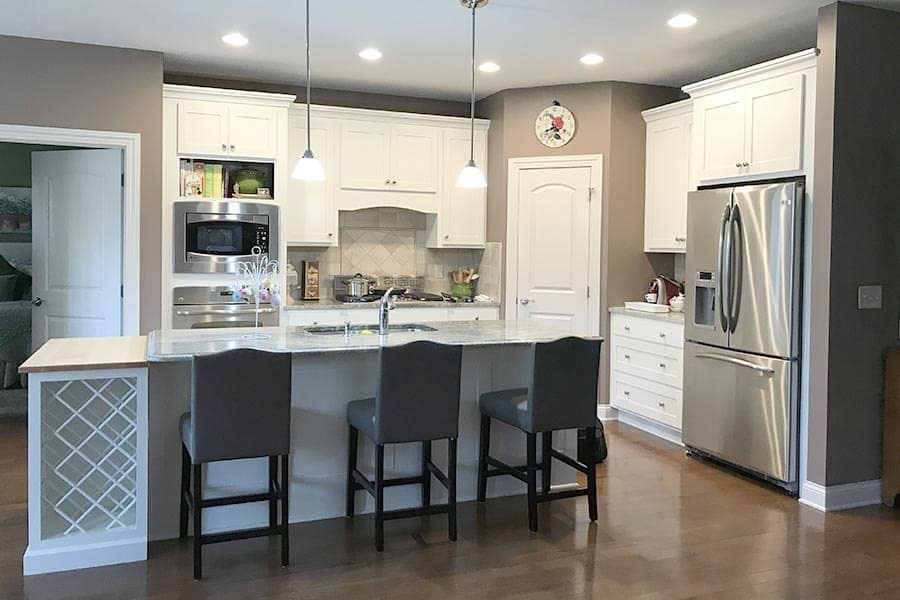 Troyer Transformations website design: one of the kitchen photos on the site, a refaced white kitchen with a gray island bar and stools