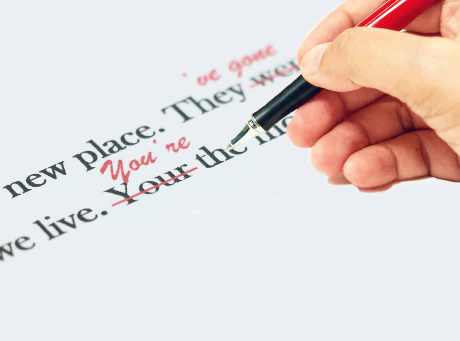 Website copywriting: printed sentences being proofread on white paper